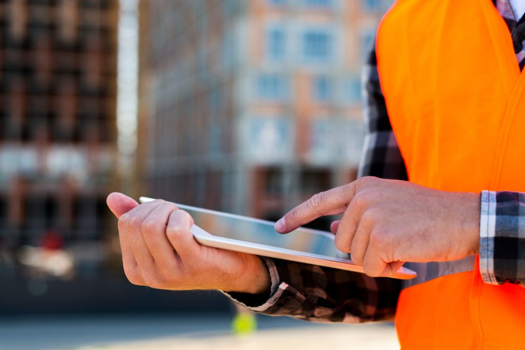Facility manager analysing security and safety measures on a digital tablet.